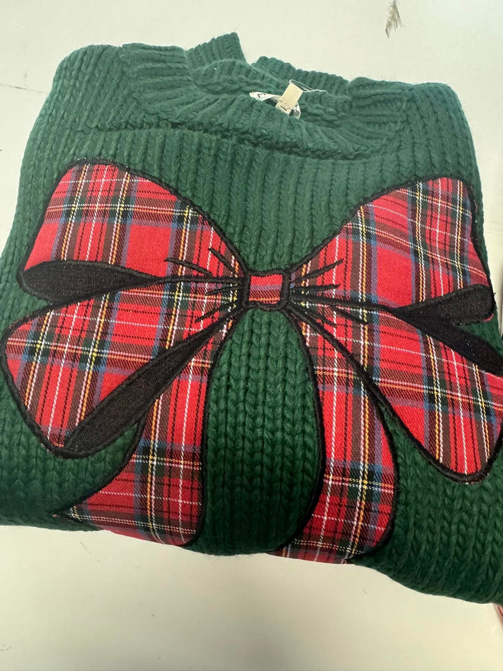 Plaid bow on green sweater